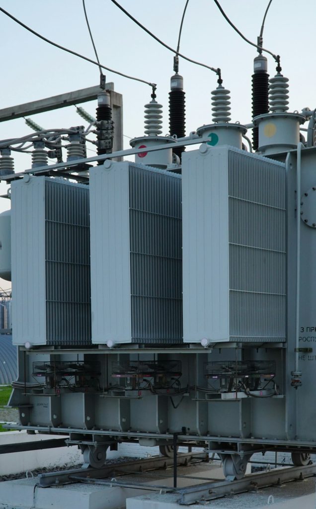 Power transformer. Electrical equipment. High voltage transformer against the blue sky.